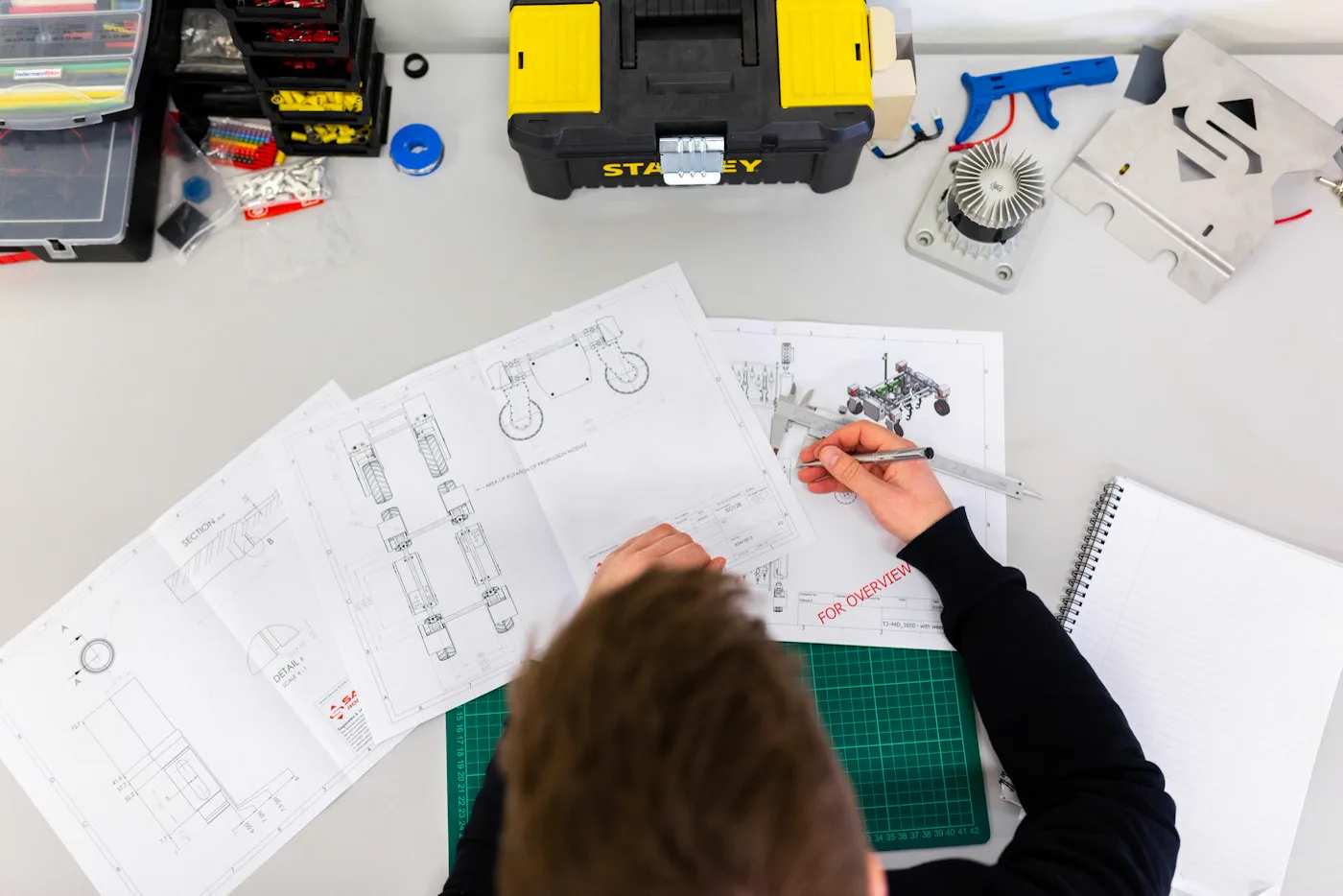 A technician reviewing installation plans and equipment